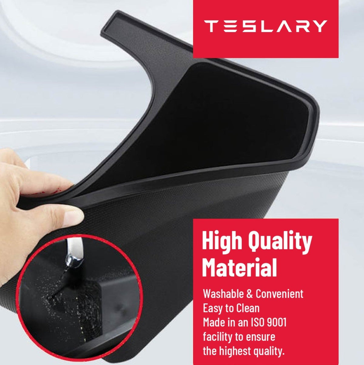 Black plastic car interior trim or console panel shown being held by a hand, with red text boxes reading TESLARY and High Quality Material, plus a circular inset demonstrating washability. TESLA_MODEL_Y_MODEL_Y_JUNIPER_REAR_STORAGE_BIN_BUY_FROM_EUROPE_AND_IRELAND_TESLARY.EU_TESLARY.IE_TESLARY.CO.UK_TESLARY.PT_TESLARY.ES
