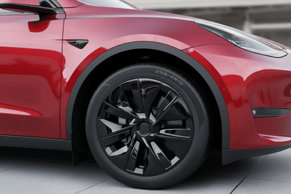 Close-up of a red vehicle wheel and fender area, showing a black multi-spoke alloy wheel with a visible 255/410 tire sidewall, set against a clean outdoor architectural background. TESLA_MODEL_Y_GLOSS_BLACK_19_WHEEL_COVERS_2022_2023_2024_2025_BUY_FROM_IRELAND_AND_EUROPES_TESLARY.EU